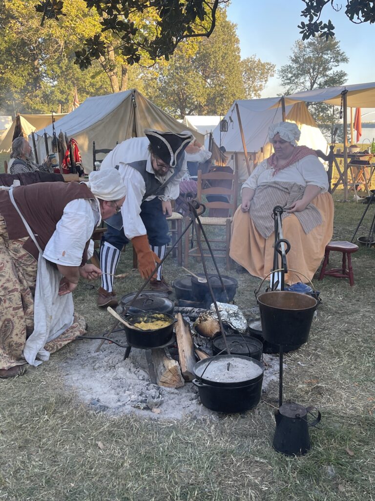 encampment cooking around a fire