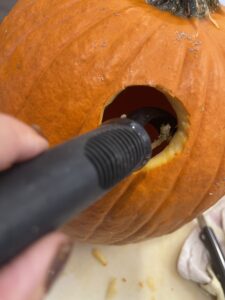 vegetable peeler to clean out windows on fairy house pumpkin