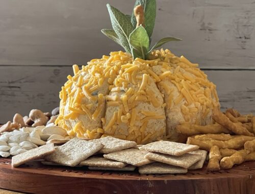 wood background pumpkin cheese ball on wooden tray