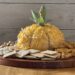 wood background pumpkin cheese ball on wooden tray