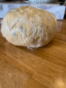 cheese ball wrapped in plastic wrap