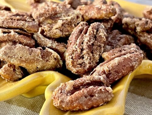 cinnamon pecans in yellow leaf dish