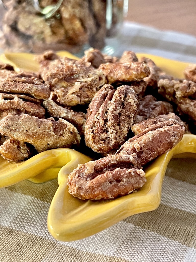 cinnamon pecans in yellow leaf dish