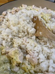 adding chicken and rice to chicken and rice casserole ingredients