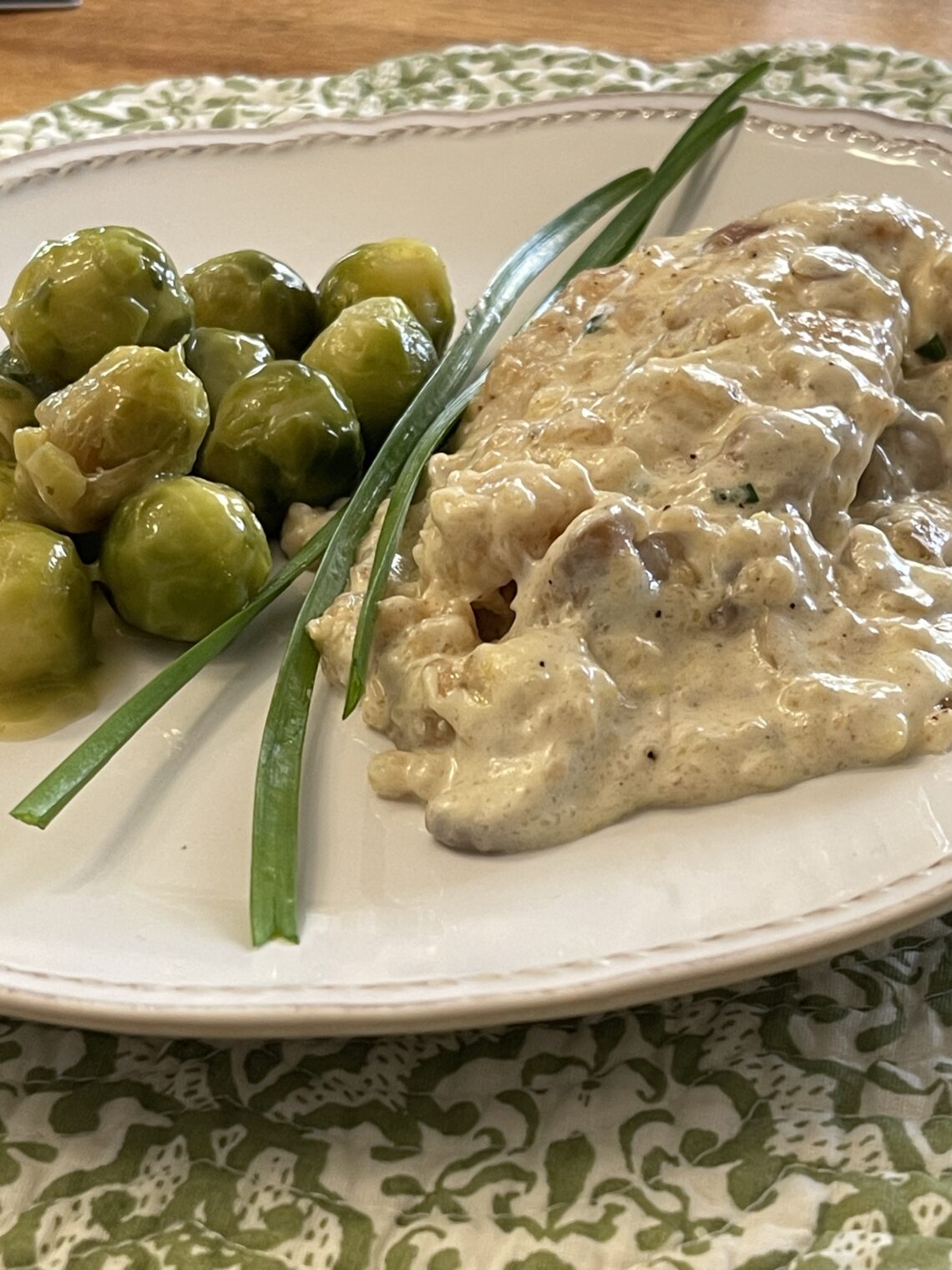 creamy lemon chicken on plate with brussel sprouts