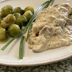 creamy lemon chicken on plate with brussel sprouts