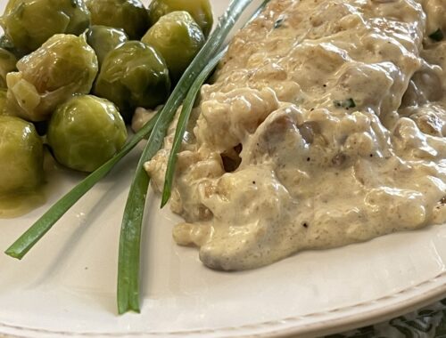 creamy lemon chicken on plate with brussel sprouts