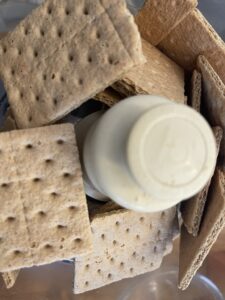 adding graham crackers to a food processor