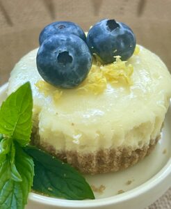 mini cheesecake with blueberries, lemon zest and mint