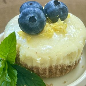 mini cheesecake with blueberries, lemon zest and mint