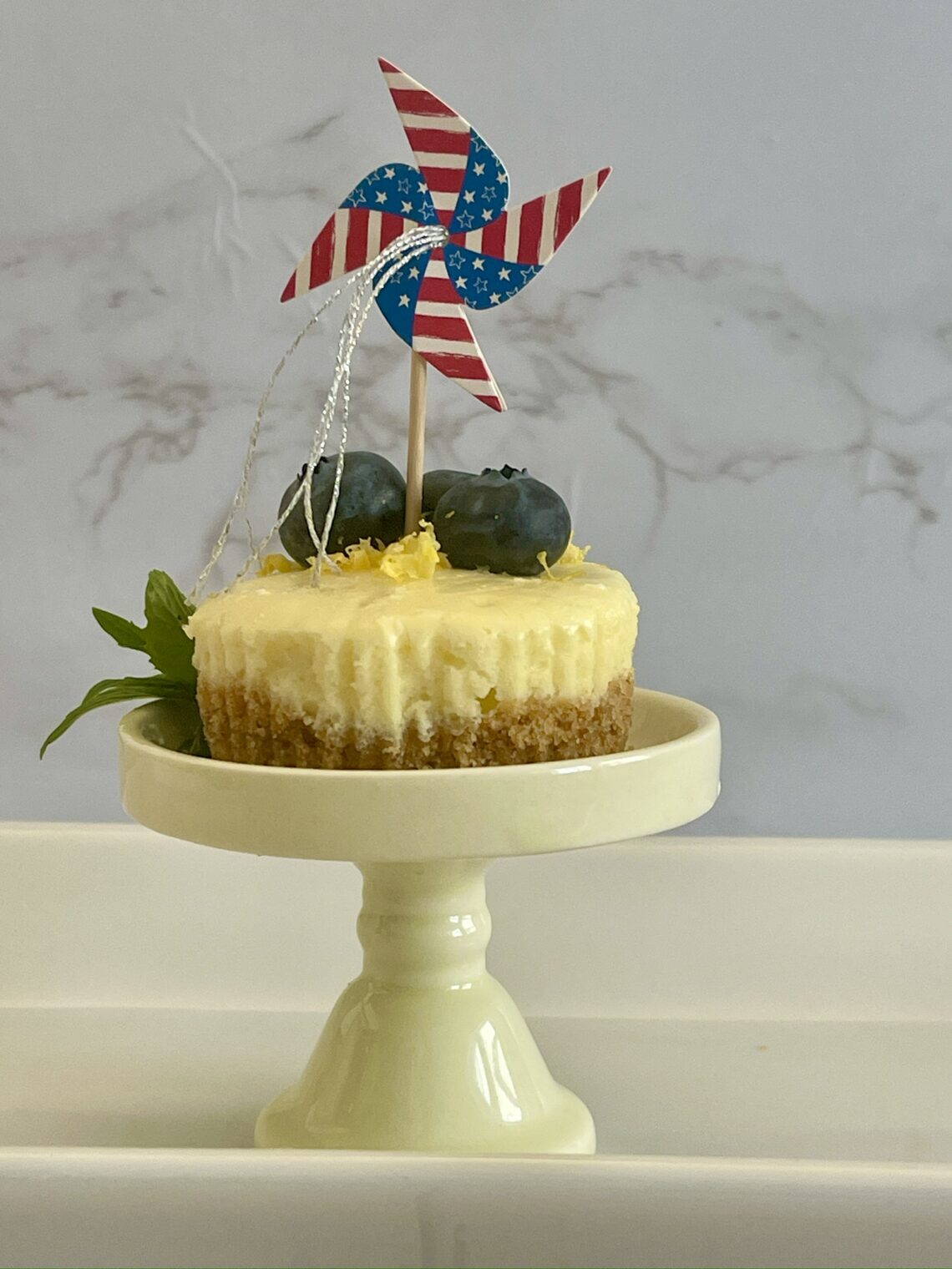 mini cheesecake with patriotic pinwheel and blueberries