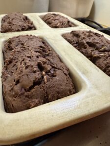 Baked double chocolate zucchini bread cooling in loaf pans