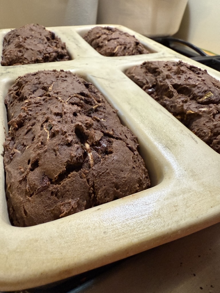 Baked double chocolate zucchini bread cooling in loaf pans