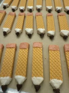 add pink erasers with pink candy melts to the pencil cookies