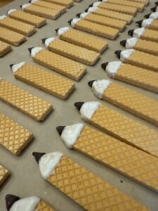 let the white chocolate harden before adding the eraser end of the pencil cookies.