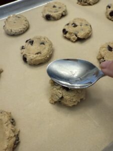 flattening s'mores cookie dough balls with back of spoon