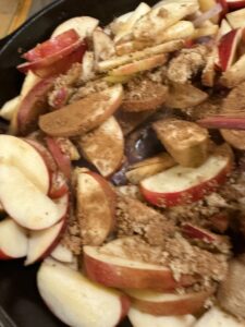 add the brown sugar, cinnamon, salt and vinegar into the apple and onion mixture for the autumn skillet pork chops and apples
