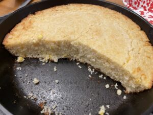 Cut slices of cornbread in cast iron skillet