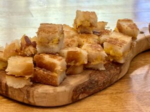 grilled cheese croutons on wooden board