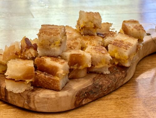 grilled cheese croutons on wooden board