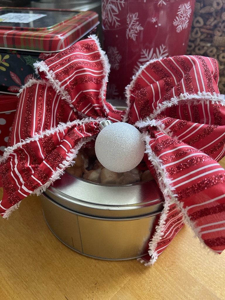 Christmas confections in a tin with a bow
