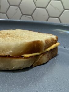 toasting a grilled cheese sandwich in a skillet to make croutons