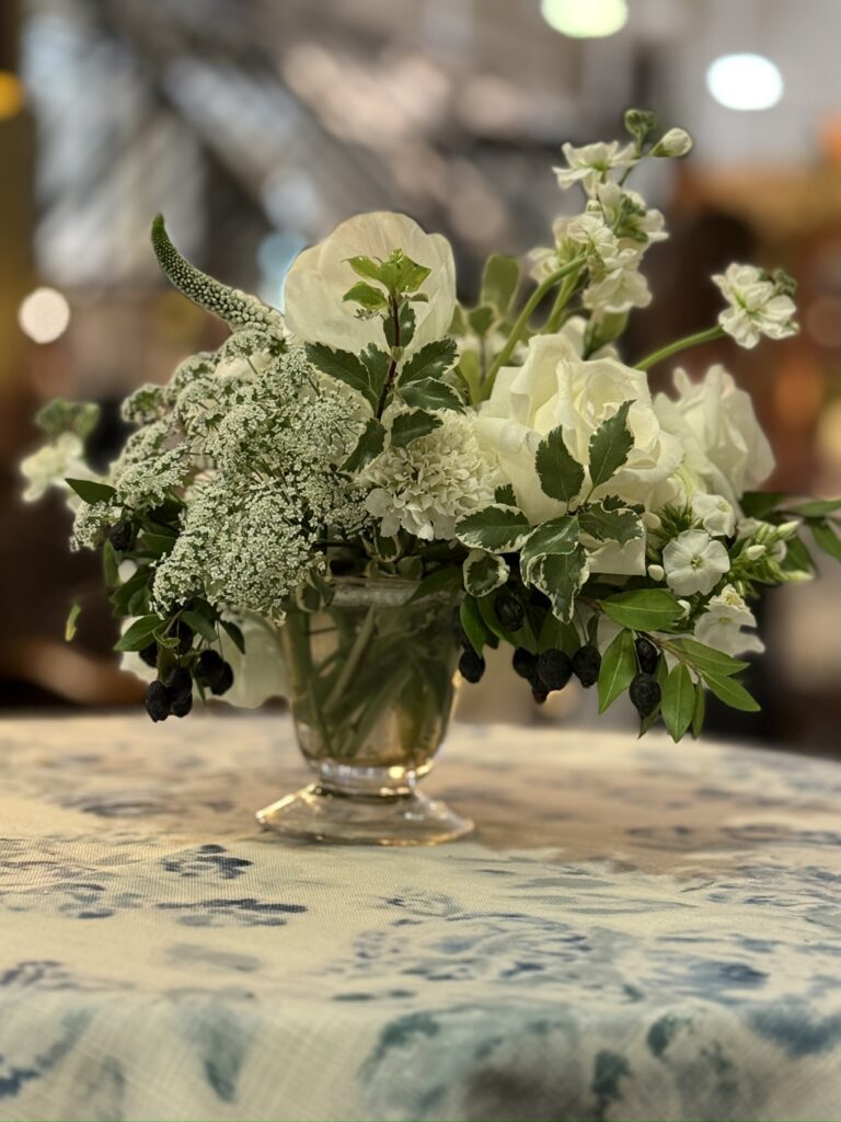 skirted table with fresh flower vase at A & G show