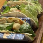 feature smashed chicken Caesar Salad Tacos