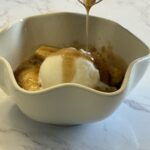 add vanilla ice cream to bananas foster in bowl