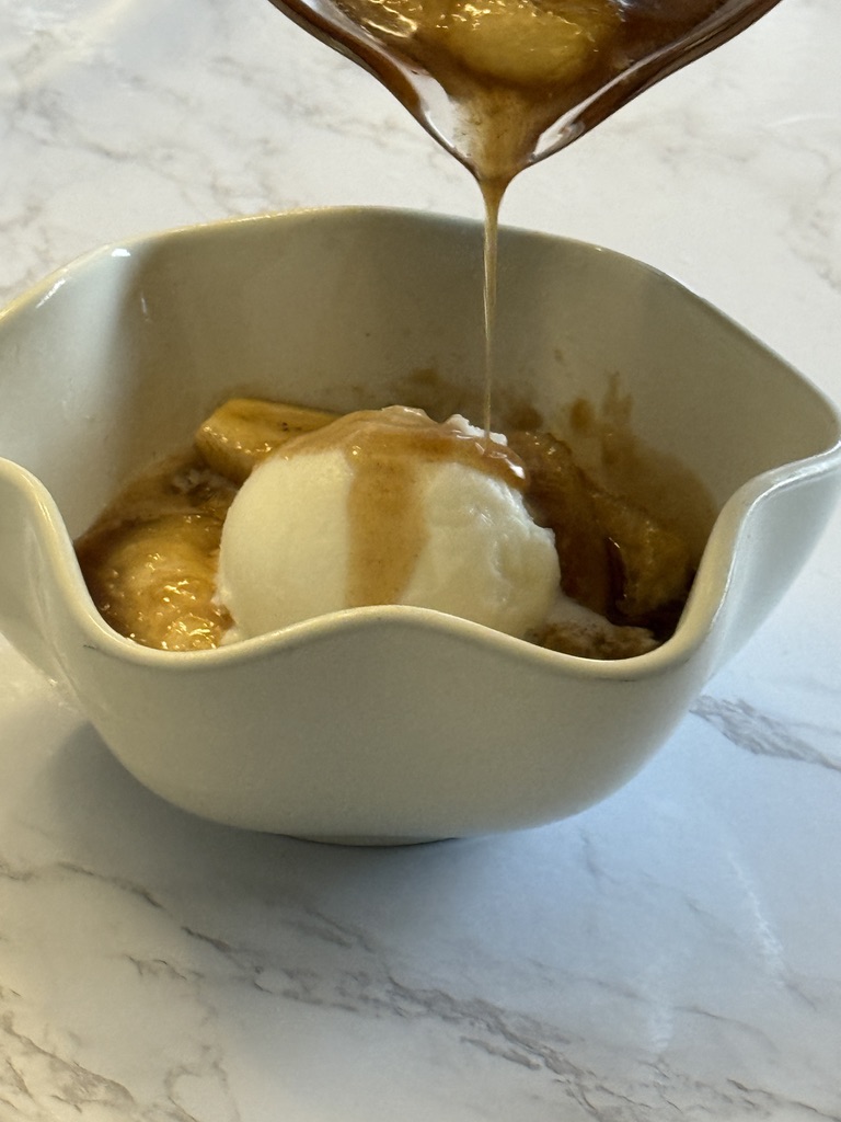 add vanilla ice cream to bananas foster in bowl