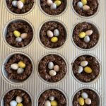 muffin tray filled with Cocoa Rice Krispies bird nests