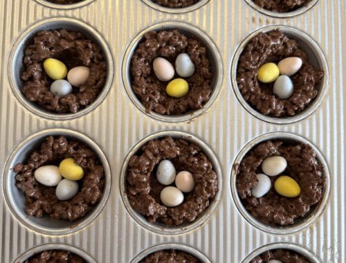 muffin tray filled with Cocoa Rice Krispies bird nests