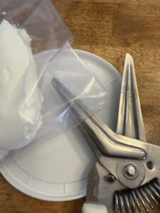 sour cream added to a bag to snip and drizzle over sheet pan nachos