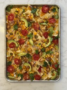 overhead view of sheet pan nachos with no sour cream drizzle