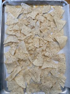 tortilla chips layer in sheet pan nachos