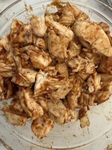 rotisserie and BBQ sauce layer of sheet pan nachos