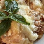 serving of baked rotini lasagna with basil added on top