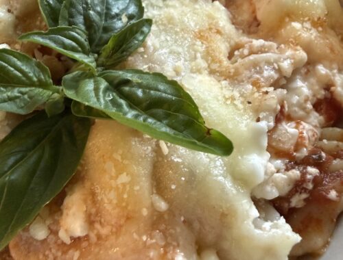serving of baked rotini lasagna with basil added on top