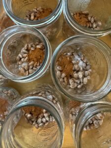 adding dried beans, salt and chili powder to pint canning jars