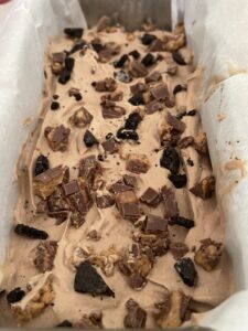 Chocolate Peanut Butter Ice Cream added to loaf pan lined with parchment paper